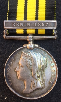 A Unique & Exceptionally Complete, East & West Africa (BENIN 1897) & 1914-15 Trio, 1911 Coronation Medal & LSGC (GV) Plaque & Scroll, Royal Navy Group of Six. With a uniformed photo of the recipient wearing his Africa medal.
